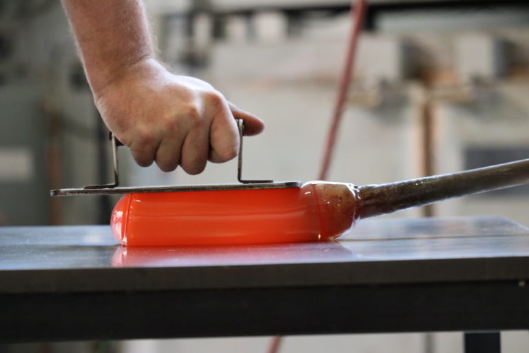 Molten glass is pressed into shape in the Glick Center.