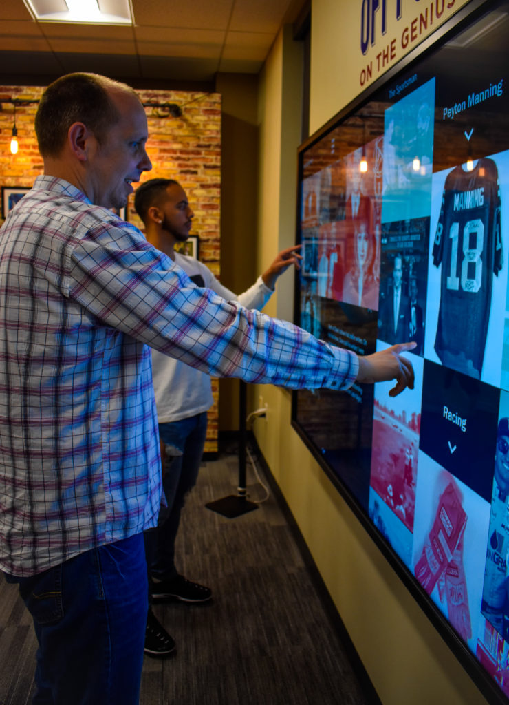 Students interact with the large touch wall experience.