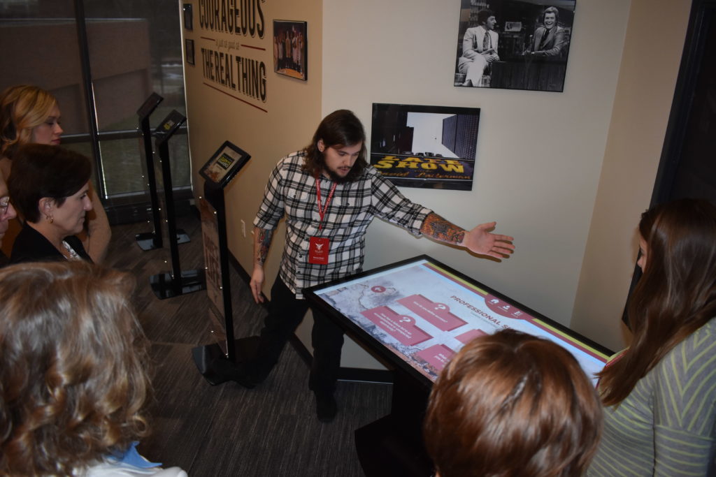 Student stands near the touch table in the letterman lab.